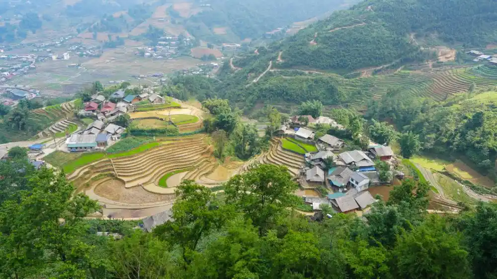 Aerial view of a Sa Pa hill-tribe village surrounded by terraced rice fields on a Homestay Trek