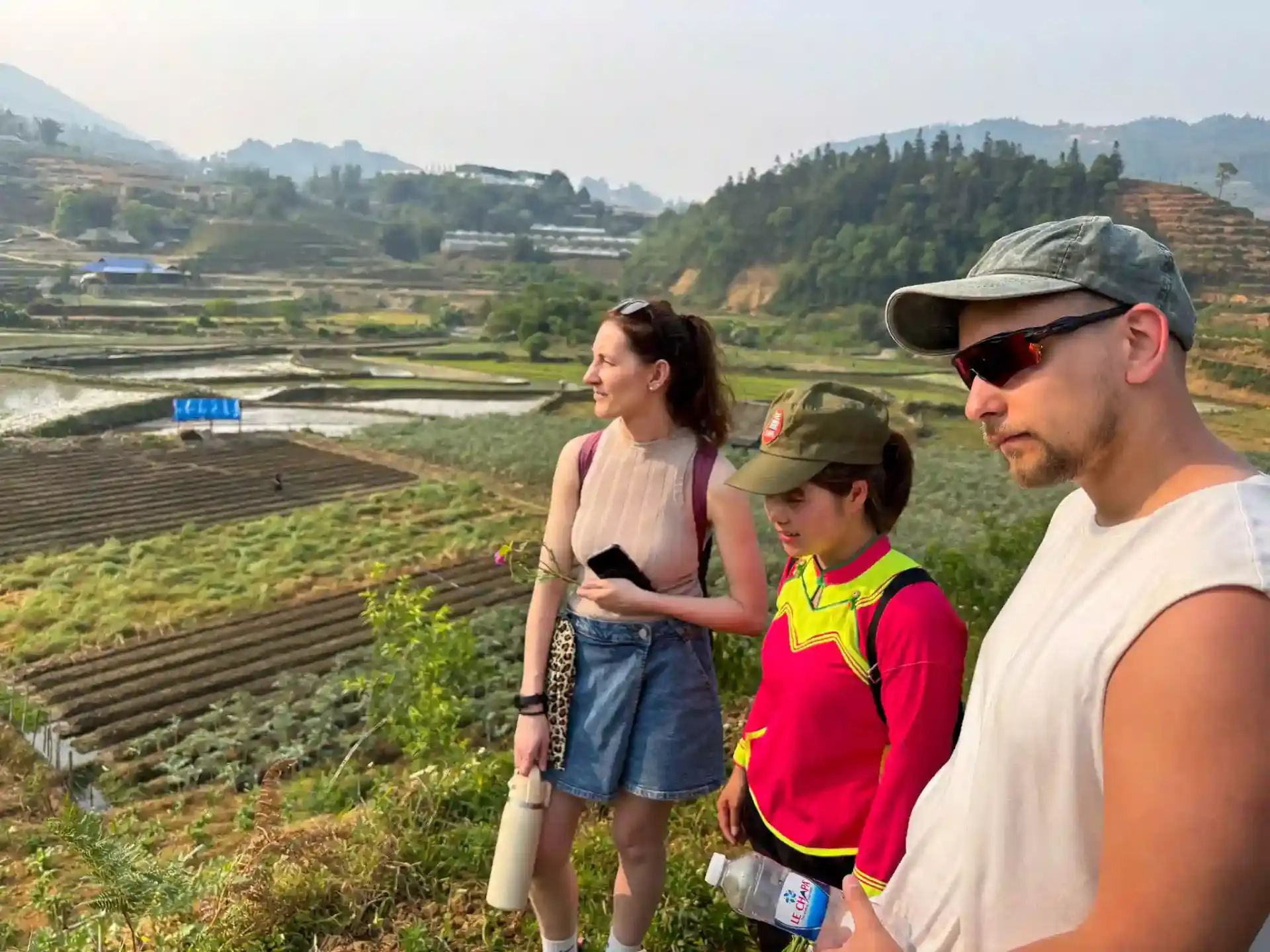 Travellers on the Sapa Countryside Walk overlooking rice terraces with a Black H'mong guide